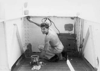 Third officer painting wing of bridge