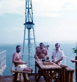 Three officers having a beer