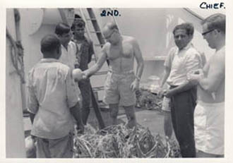 Buying fruit from seller on deck