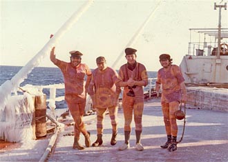 4 enginn=eers on deck in fancy dress.